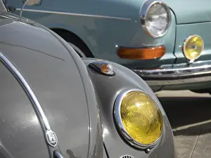 Close-up of a grey vintage car with yellow headlights