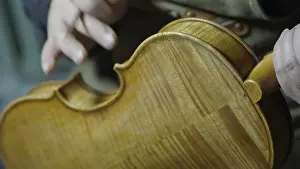 Close-up of a person working on a violin