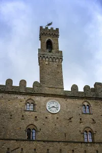 A close-up of the Priori Palace tower in Volterra