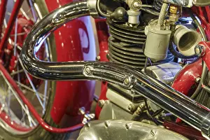 Close-up of a red motorbike with shiny exhaust and engine