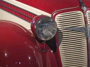 Close-up of a red vintage car with headlights