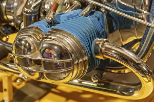 Close-up of a shiny motorbike with blue and chrome-coloured elements