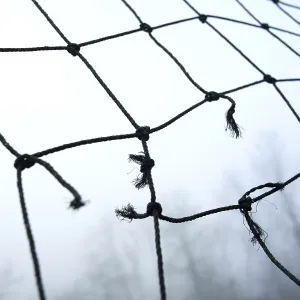A close-up view of worn netting with frayed edges
