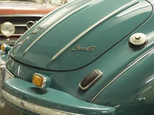 Close-up of a vintage car back in blue with chrome-plated bumper and details
