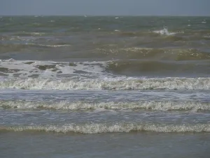 Close-up of waves at the sea breaking with foam