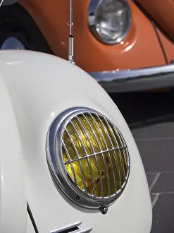 Close-up of a white classic car with yellow headlight