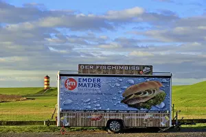 Closed fish snack car stands on the car park in front of the Pilsum lighthouse
