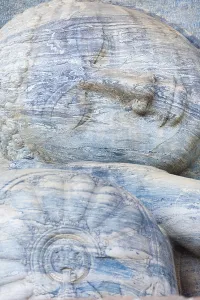 A closeup of the monolithic reclining Buddha statue