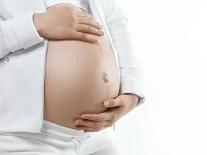 Closeup of a pregnant young woman belly