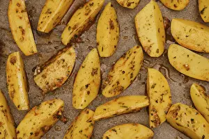 Closeup top view of potato wedges baked in oven