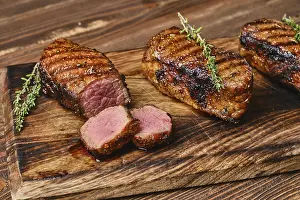 Closeup view of roasted beef brisket flat steak on wooden cutting board