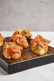 Closeup view of sandwich with salmon and mashed avocado
