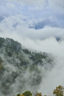 Clouds lying in the valley between Mountains at Hochalpenstrasse