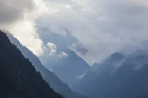 Framed Print : Cloudy atmosphere with forest and mountains