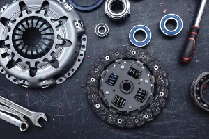 Clutch kit with tools and bearings on a workshop surface