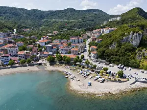Coastal area with beach and boats on a coastal road