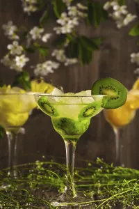 Three cocktails: pineapple, orange, kiwi