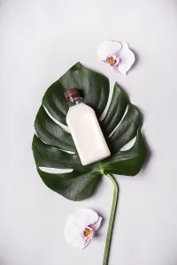Coconut oil and tropical leaves and flowers