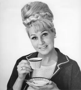 Coffee in the 1960s. A woman is drinking coffee from a coffeecup with a 1960s striped pattern
