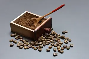 Coffee, ground coffee in the drawer of a coffee grinder and coffee beans