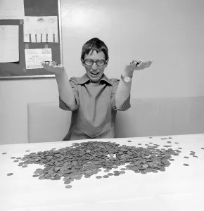Coins. A woman with a large amount of coins in front of her, looking really happy. 1971. Conard ref 6019