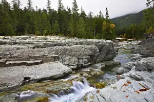 Cold stream and autumn fog in mountains