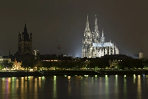 The Cologne Cathedral illuminated at night with Rhine