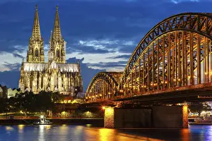 Cologne Cathedral Skyline and Hohenzollern Bridge with Rhine River in Germany at night in Cologne