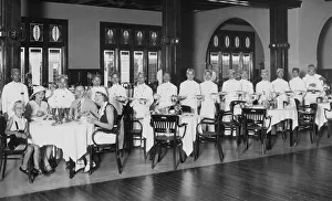 Colonial history, waiters take care of a family of four in the restaurant
