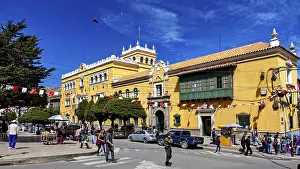 Category Cities DE Prints: Colonial-style building with market scene and decorative flags