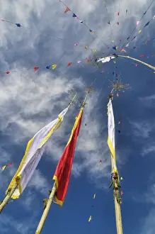 Colorful buddhist prayer flags and standards on poles in Pathivara Devi