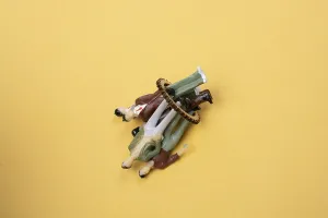 Colorful diverse miniature people figurines make crowd on ground