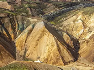 Colorful rhyolite mountains, lava field below mt