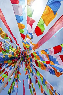 Colorful tibetan buddhist praying flags in the wind next to Chaqia salt lake