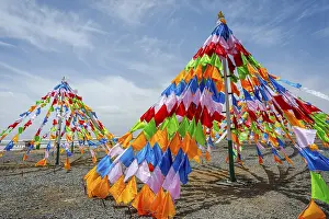 Colorful tibetan buddhist praying flags in the wind next to Chaqia salt lake