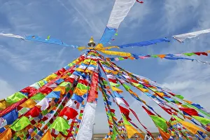 Colorful tibetan buddhist praying flags in the wind next to Chaqia salt lake