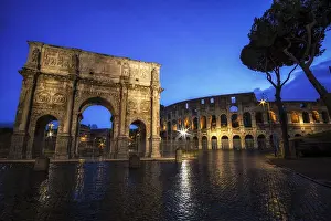 Colosseum and Constantine Arch at Night with the light trails in the nearby road