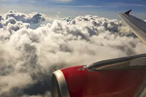 A colour landscape image looking out through airplane window showing land