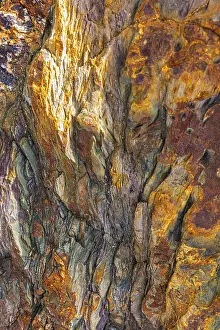 Coloured, ferrous mineral rocks on the beach of Topinetti