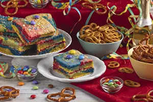 Colourful cakes, pretzels and sweets on a richly decorated table