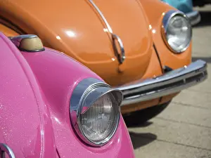 Colourful classic cars with shiny headlights in the sun