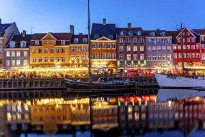 Category Scandinavia Prints: Colourful houses, restaurants and historic ships on the Nyhavn canal and harbour at dusk