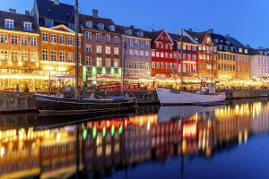 Colourful houses, restaurants and historic ships on the Nyhavn canal and harbour at dusk