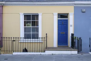 Colourful townhouse with blue door and yellow facade
