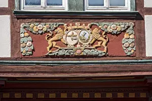Colourfully painted carvings, lions with coat of arms medallions
