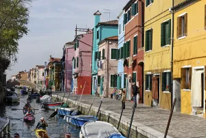 Colourfully painted houses along a canal on Burano, an island in the Venetian Lagoon, Italy, Europe