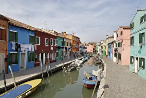 Colourfully painted houses along a canal on Burano