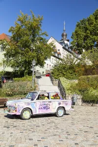 Colourfully painted and planted Trabant car on the old market in Hohenstein-Ernstthal