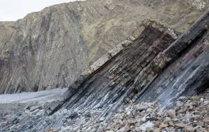 Complex folding of sedimentary rock strata in coastal cliffs at Hartland Quay