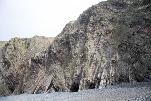 Complex folding of sedimentary rock strata in coastal cliffs at Hartland Quay